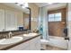 Bathroom with double sinks, a shower/tub combo, and updated fixtures at 3507 Autumn Glen Dr, Valrico, FL 33596