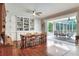 Dining room with hardwood floors, built-ins, and pool access at 3507 Autumn Glen Dr, Valrico, FL 33596