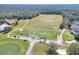 Aerial view of a golf course driving range with golfers practicing at 3507 Autumn Glen Dr, Valrico, FL 33596