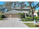 Two-story house with a three-car garage and landscaped lawn at 3507 Autumn Glen Dr, Valrico, FL 33596