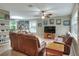 Spacious living room with brown leather sofas and a large TV at 3507 Autumn Glen Dr, Valrico, FL 33596