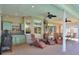 Outdoor patio with built-in kitchen, seating area, and ceiling fans at 3507 Autumn Glen Dr, Valrico, FL 33596
