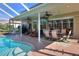Inviting pool area with covered patio, outdoor seating, and a dining area at 3507 Autumn Glen Dr, Valrico, FL 33596