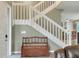 Wooden staircase with white railings and storage bench at 3507 Autumn Glen Dr, Valrico, FL 33596