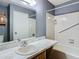 Bathroom features a vanity, tub shower combo, and grab bars at 4531 Blossom Blvd # 4531, Zephyrhills, FL 33542