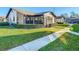 View of the home's exterior, showcasing a side entrance and landscaping at 4531 Blossom Blvd # 4531, Zephyrhills, FL 33542
