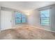 Simple living room featuring neutral walls, carpet, and large windows at 4531 Blossom Blvd # 4531, Zephyrhills, FL 33542