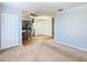 Open living and kitchen area with neutral colors and carpet flooring at 4531 Blossom Blvd # 4531, Zephyrhills, FL 33542