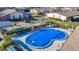 Community pool with a safety cover, surrounded by a patio and seating at 4531 Blossom Blvd # 4531, Zephyrhills, FL 33542