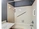Walk-in shower with grab bars and tiled walls at 4531 Blossom Blvd # 4531, Zephyrhills, FL 33542