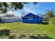 Blue house with a spacious backyard and green lawn at 1106 Powell St, Plant City, FL 33563