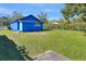 Blue house with a large backyard and green grass at 1106 Powell St, Plant City, FL 33563