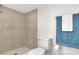 Updated bathroom with patterned shower tile and a white toilet at 1106 Powell St, Plant City, FL 33563