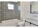 Updated bathroom with patterned tile and white vanity at 1106 Powell St, Plant City, FL 33563