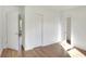 Bright bedroom with wood-look floors and multiple closets at 1106 Powell St, Plant City, FL 33563