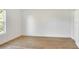 Spacious bedroom featuring wood-look floors and a large window at 1106 Powell St, Plant City, FL 33563