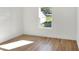 Charming bedroom with backyard view and wood-look floors at 1106 Powell St, Plant City, FL 33563