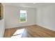 Spacious bedroom with hardwood floors and a window at 1106 Powell St, Plant City, FL 33563