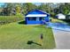 Blue house with a small yard and driveway at 1106 Powell St, Plant City, FL 33563