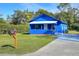 Charming blue house with a well-maintained lawn and a driveway at 1106 Powell St, Plant City, FL 33563