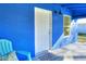 Bright blue front porch with teal chairs and welcome mat at 1106 Powell St, Plant City, FL 33563