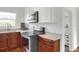 Updated kitchen with stainless steel appliances and wood cabinets at 1106 Powell St, Plant City, FL 33563