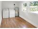 Laundry room with washer, dryer, and light wood floors at 1106 Powell St, Plant City, FL 33563