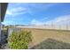 Rear yard view of the home, showcasing the AC unit and a privacy fence at 3510 N Maryland Ave, Plant City, FL 33565