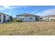Single-story house back with a covered patio, grassy yard, and privacy fence at 3510 N Maryland Ave, Plant City, FL 33565