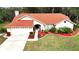 Top-down view of a house showcasing its red roof, landscaping, and driveway at 3633 Nettle Creek Ct, Holiday, FL 34691