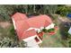 Aerial view of a single-story house with red roof and a pool in the backyard at 3633 Nettle Creek Ct, Holiday, FL 34691