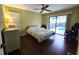 Bedroom with pool view and dark wood floors at 3633 Nettle Creek Ct, Holiday, FL 34691