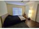 Cozy bedroom with wood floors and a guitar at 3633 Nettle Creek Ct, Holiday, FL 34691