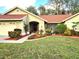 Attractive single-story home with red roof, landscaping, and a well-manicured lawn at 3633 Nettle Creek Ct, Holiday, FL 34691