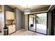 Kitchen with view of pool and patio through sliding doors at 3633 Nettle Creek Ct, Holiday, FL 34691