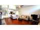 Open living space with hardwood floors, sofa, and kitchen views at 3633 Nettle Creek Ct, Holiday, FL 34691
