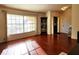 Bright living room with hardwood floors, large window, and corner cabinet at 3633 Nettle Creek Ct, Holiday, FL 34691