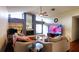 Living room featuring a fireplace, large TV, and comfortable seating at 3633 Nettle Creek Ct, Holiday, FL 34691