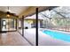 Inviting pool and patio area with screened enclosure at 3633 Nettle Creek Ct, Holiday, FL 34691