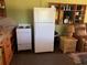 Galley kitchen includes a refrigerator, stove, and wood cabinets at 750 Charlie Taylor Rd, Plant City, FL 33566