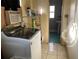 Laundry room with washer, dryer, and storage shelving at 750 Charlie Taylor Rd, Plant City, FL 33566