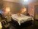 Main bedroom with a king-size bed and dark hardwood floors at 750 Charlie Taylor Rd, Plant City, FL 33566