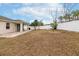 Large grassy backyard with a patio at 269 Fairmont Dr, Spring Hill, FL 34609