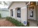 Front entrance of the house with landscaping and ADT security system at 269 Fairmont Dr, Spring Hill, FL 34609
