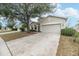 Tan two-story house with driveway at 269 Fairmont Dr, Spring Hill, FL 34609