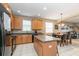 Open kitchen with island, wood cabinets, and black appliances at 269 Fairmont Dr, Spring Hill, FL 34609