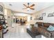 Living room open to kitchen, featuring a ceiling fan and comfortable seating at 269 Fairmont Dr, Spring Hill, FL 34609