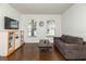 Living room with hardwood floors, large windows, and a flat screen TV at 269 Fairmont Dr, Spring Hill, FL 34609
