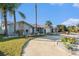 Newly renovated home with light blue exterior, palm trees, and a circular driveway at 5001 Marlin Dr, New Port Richey, FL 34652