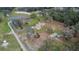 Aerial view of home on a large lot with a pond and outbuildings at 5401 Peeples Rd, Plant City, FL 33565